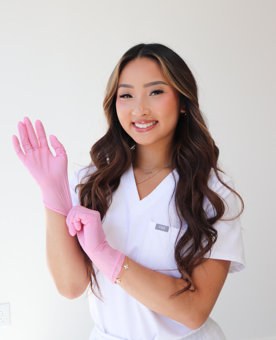 Britney Vu in white scrubs